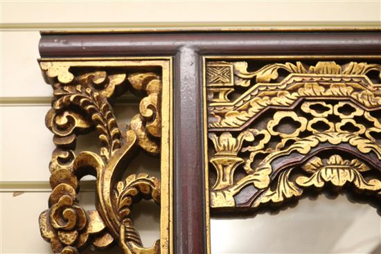 A Chinese carved and parcel-gilt wall mirror W.122cm